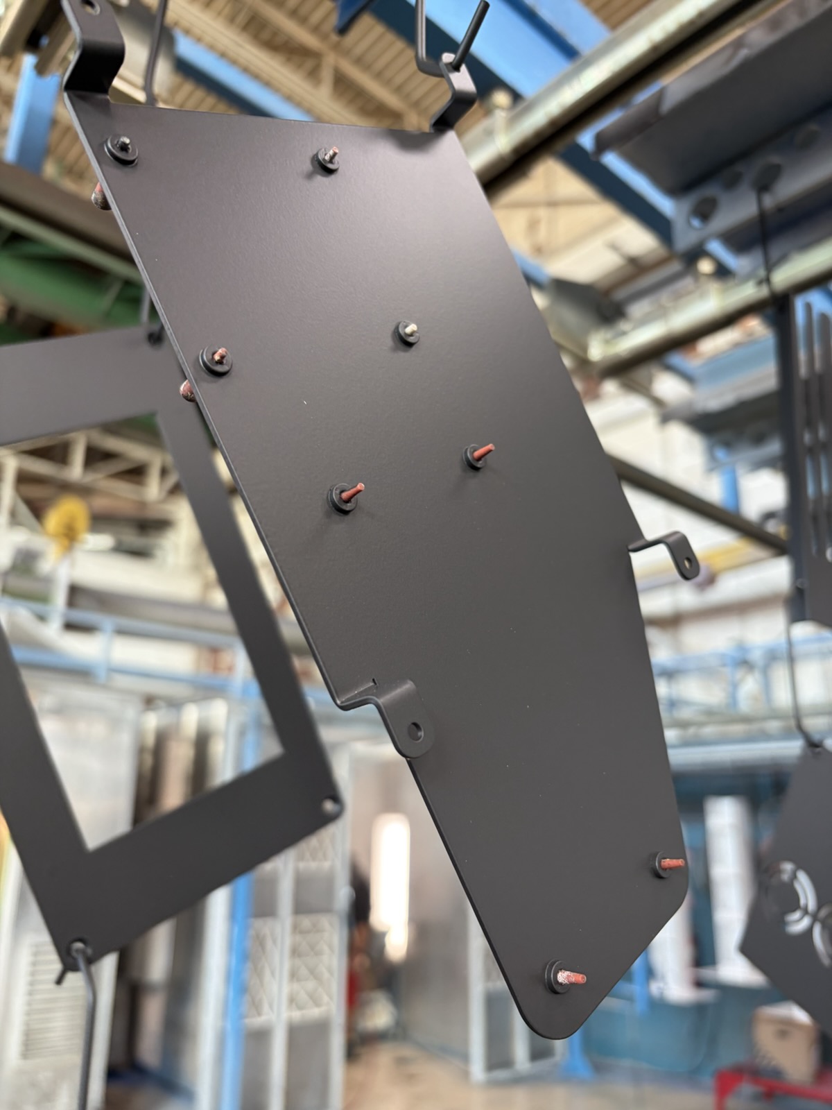 Black powder coated steel panel on coating line